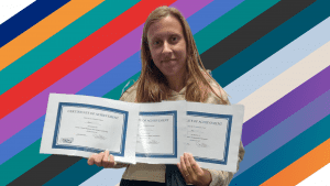 Amy holding her certificates